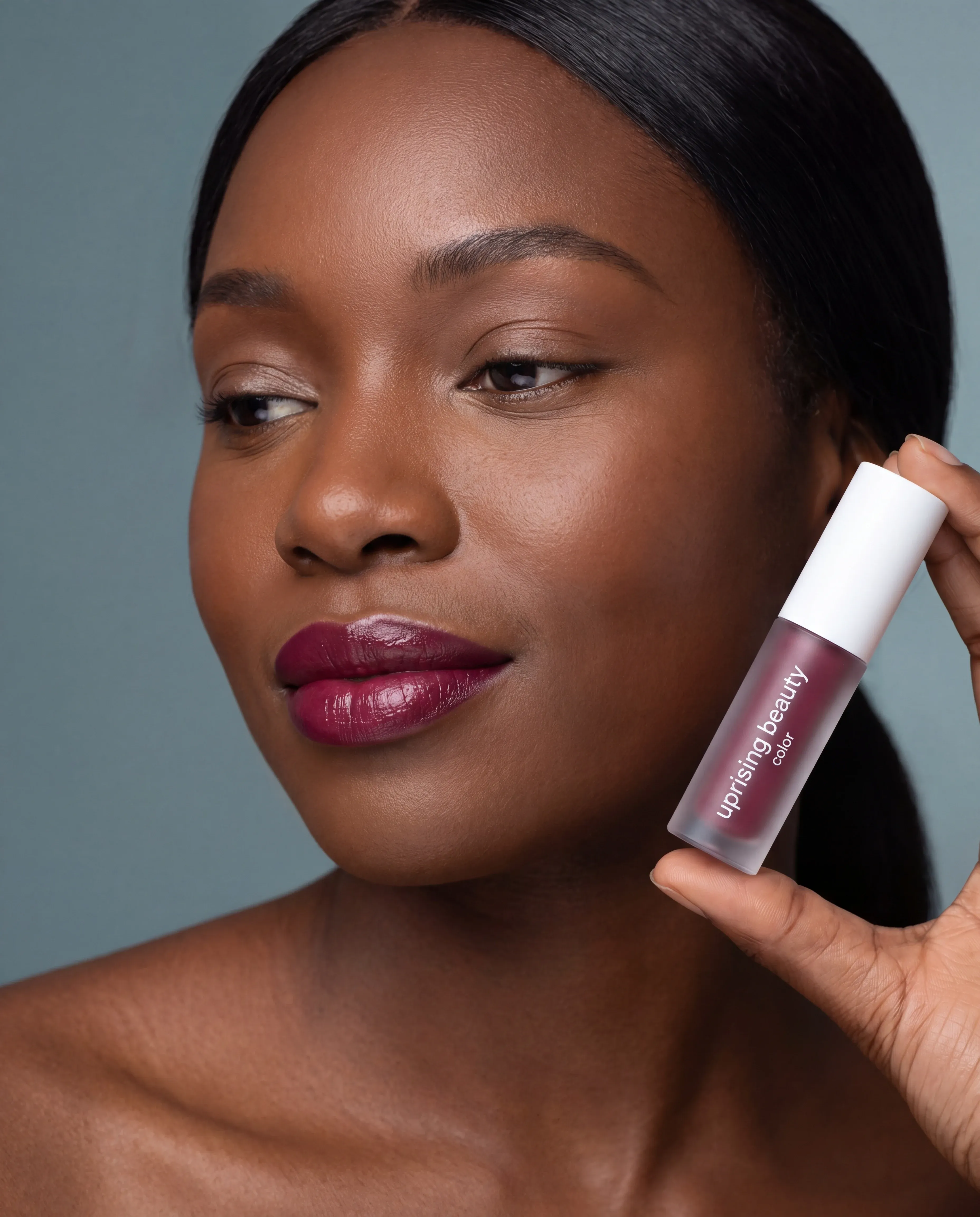 Color cosmetics editorial composition, foundation swatch and lip tone on a model's face
